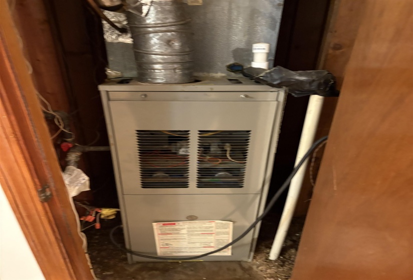 Utility room featuring heating unit