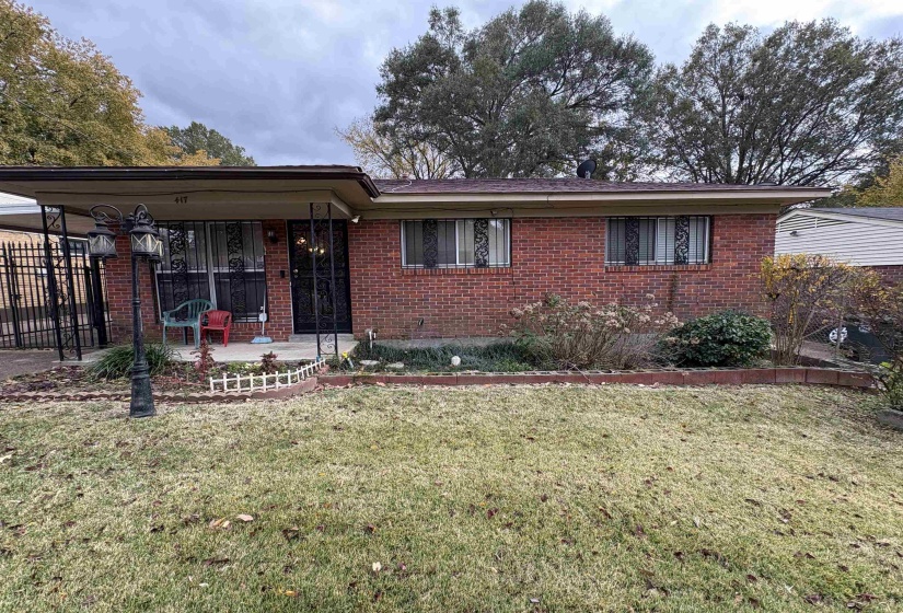 Single story home featuring brick siding and a porch