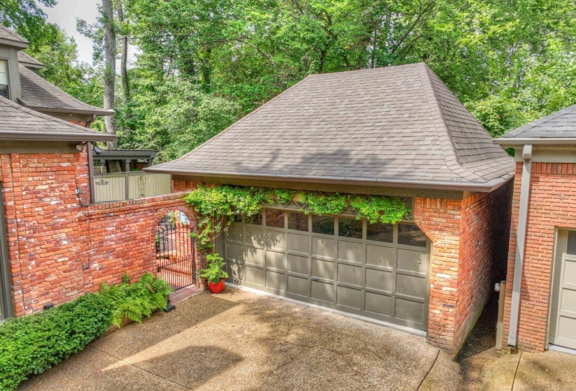View of patio featuring a gate and a detached garage