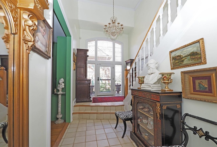 Foyer entrance featuring suspended lighting, a high ceiling, and light tile patterned flooring