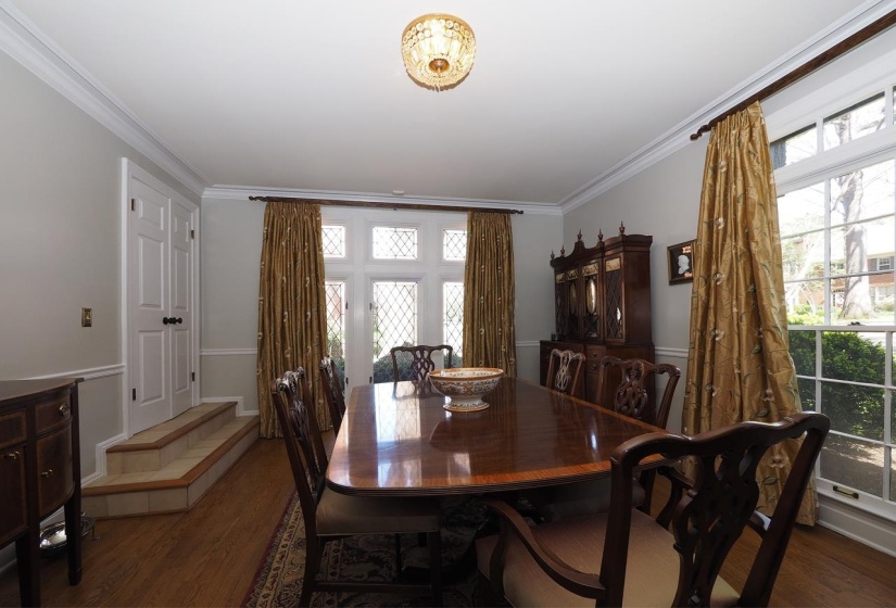 Dining area with dark wood finished floors and ornamental molding