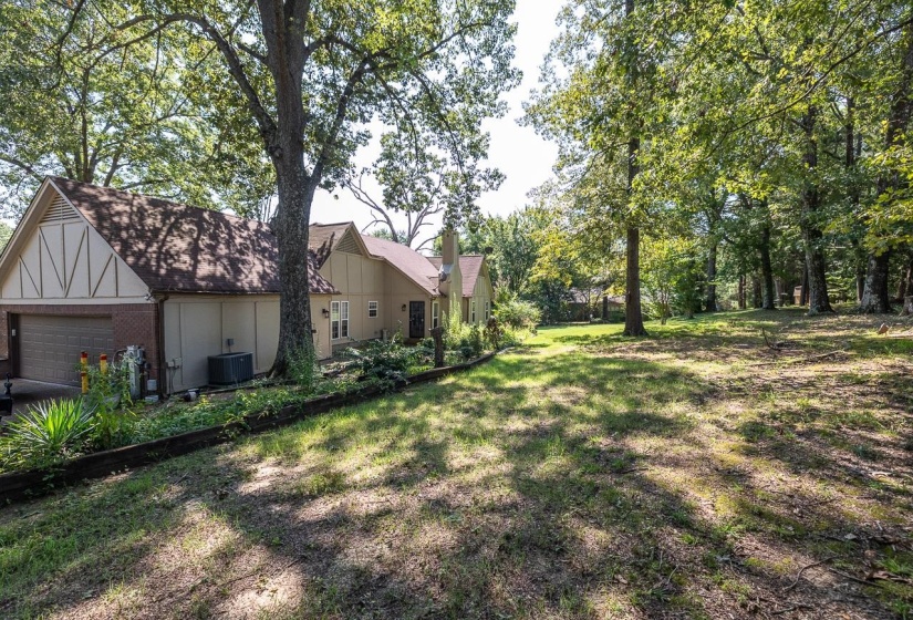 View of grassy yard with an attached garage