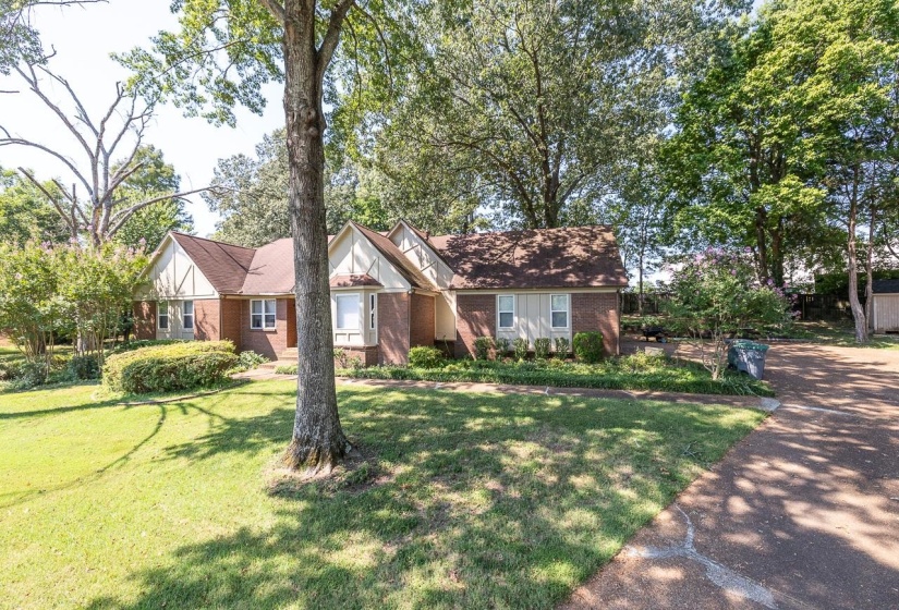 View of front of home with brick siding and a front yard