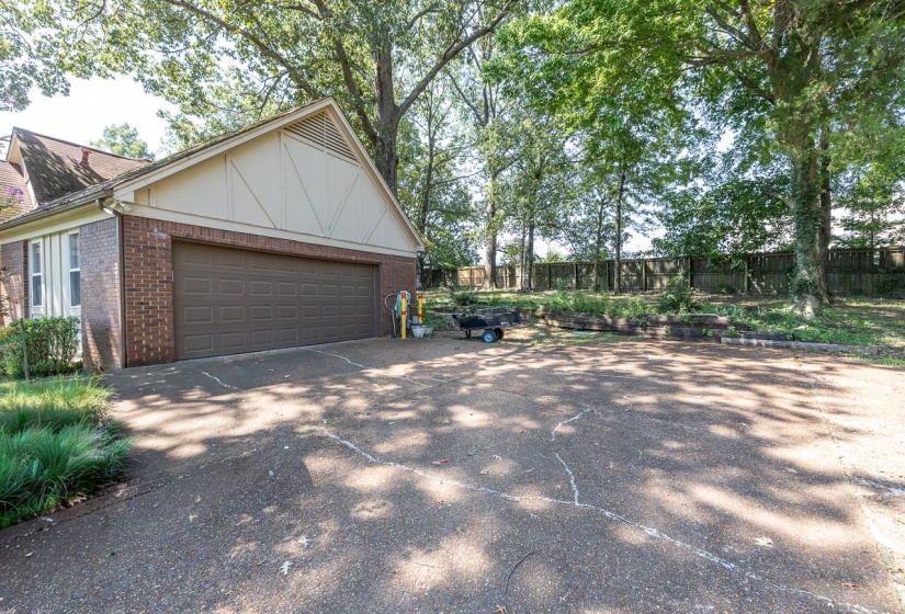 View of side of property with brick siding and driveway
