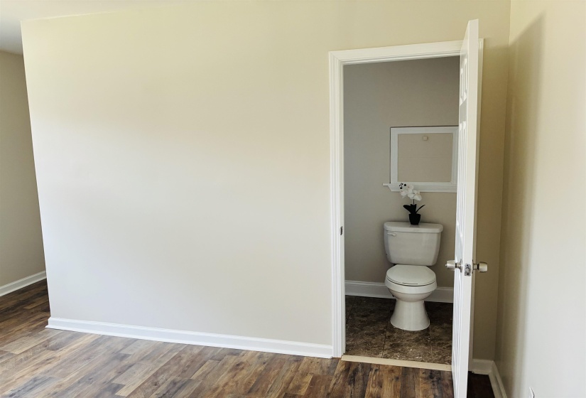 Bathroom with toilet and dark wood-style floors