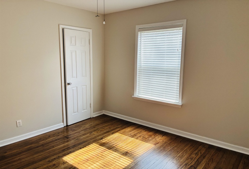 Spare room featuring dark wood finished floors