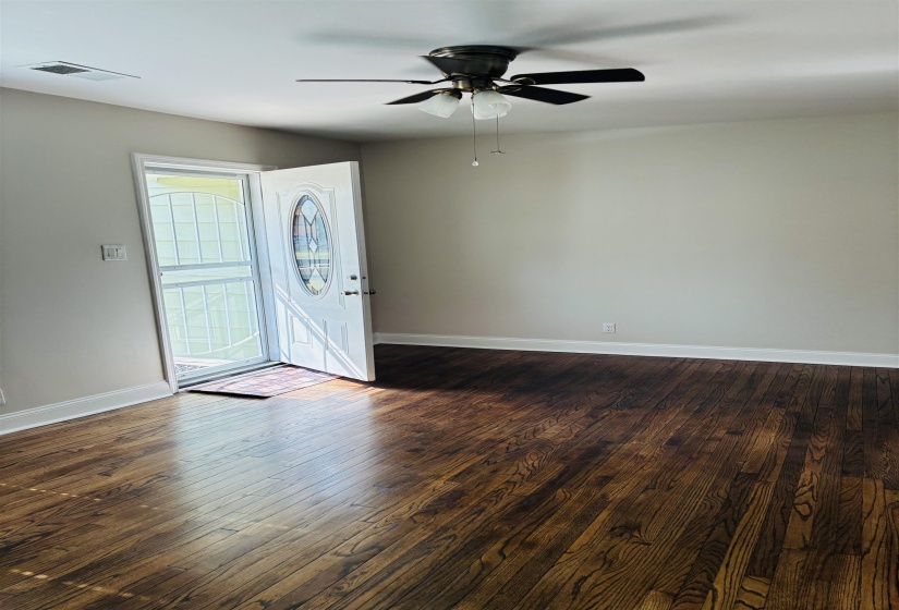 Entryway with dark wood finished floors and ceiling fan