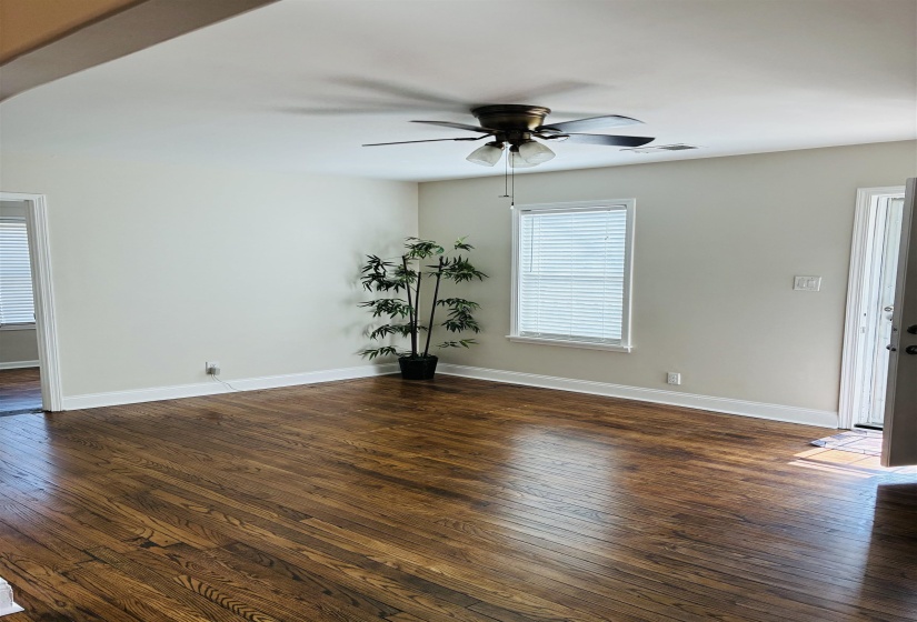Spare room featuring dark wood finished floors and ceiling fan