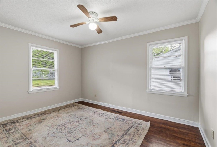 Neutral wall paint, wood-finish flooring, and white trim