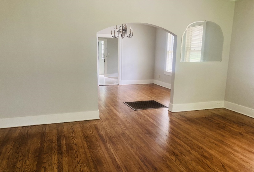 Interior space featuring wood-finish flooring, light-toned wall paint, and white trim