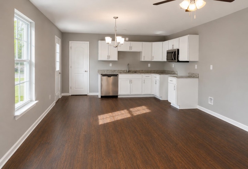 Open-concept living area with dark wood-finish flooring