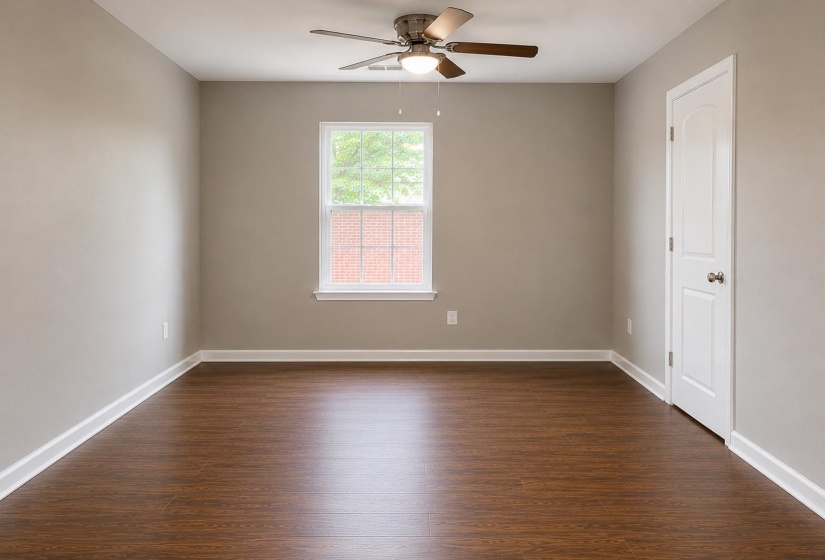 Room featuring wood-finish flooring, a white trim package, and a ceiling fan with light fixture