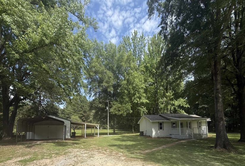 Single-story residence featuring a covered front porch and white siding