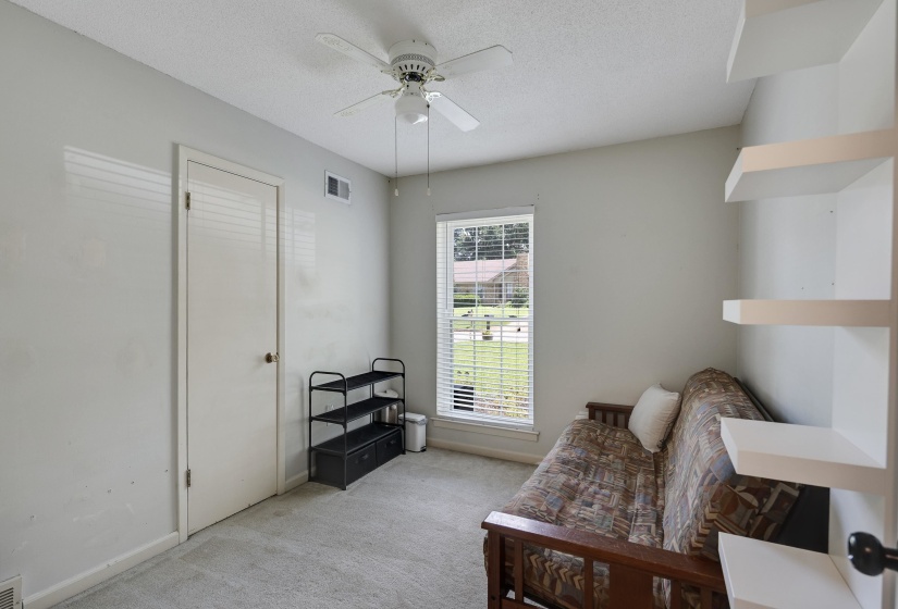 Room with light gray walls, textured ceiling, and gray carpet flooring