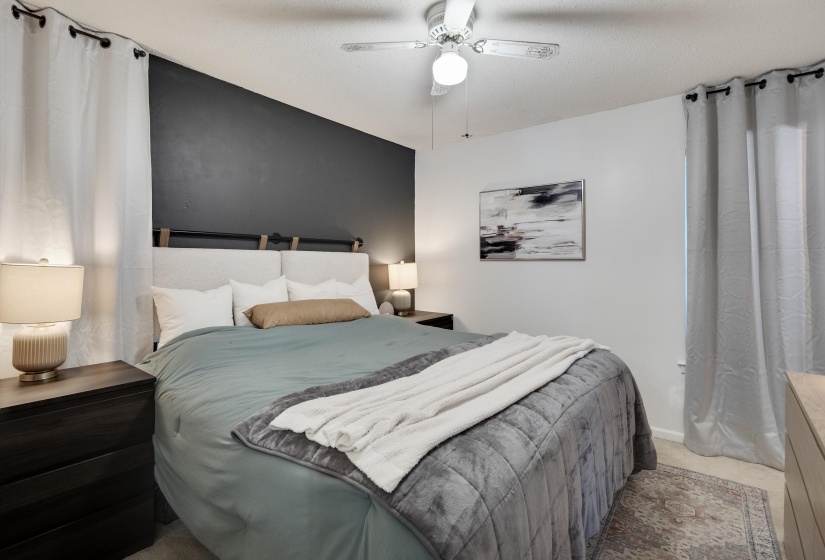 Bedroom with an accent wall and ceiling fan
