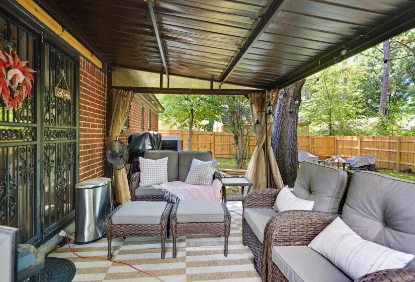 Covered patio with a metal roof and brick exterior