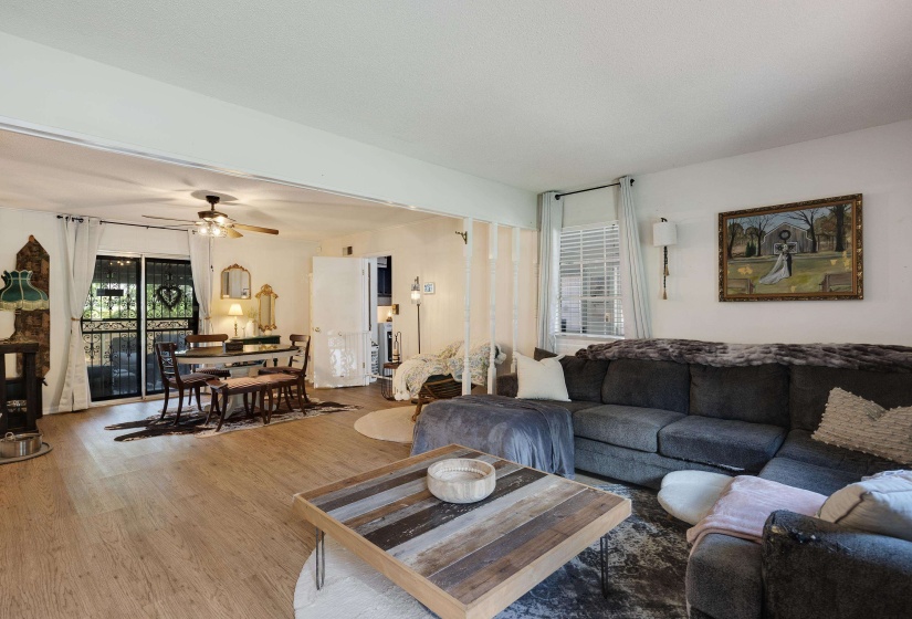 Open concept living area with wood-finish flooring