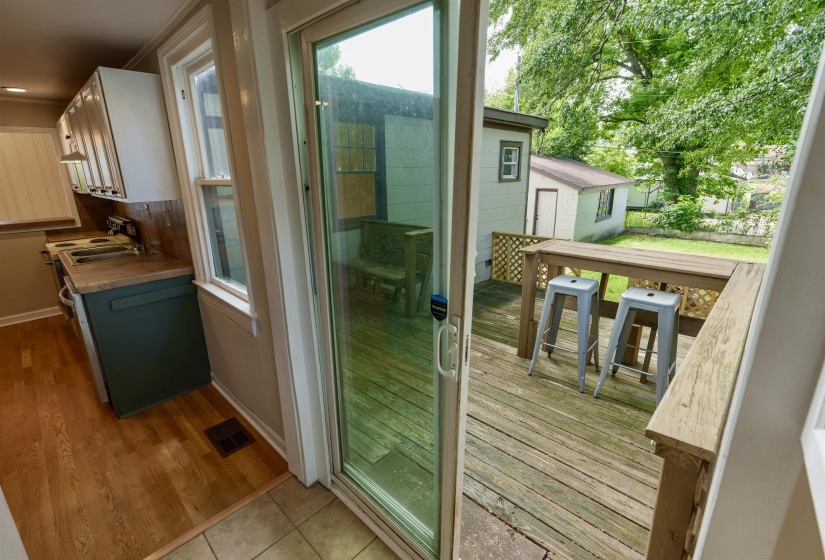 Outdoor deck with a built-in railing, offering exterior access and a view of the backyard