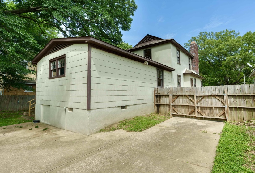 Two-story residence featuring light-colored siding and a contrasting brown trim