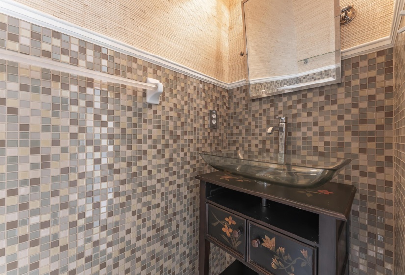 Mosaic tile wainscoting and a textured wall covering