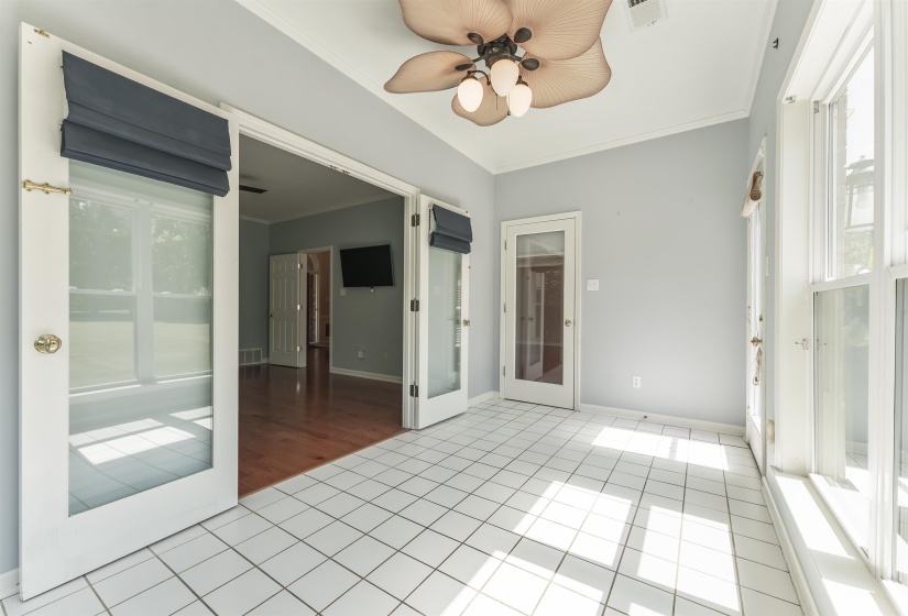 Bright room featuring white square tile flooring and light gray walls