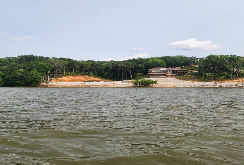 Water view with a heavily wooded area