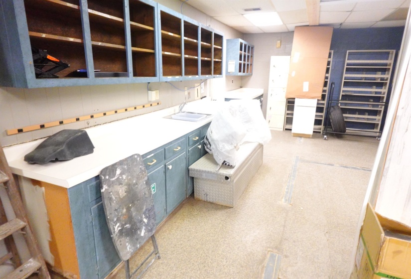 Miscellaneous room with a paneled ceiling and a sink