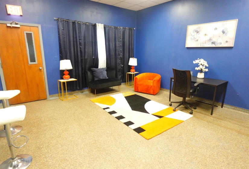 Carpeted office space with a drop ceiling