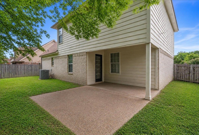 Expansive concrete patio offering covered outdoor space
