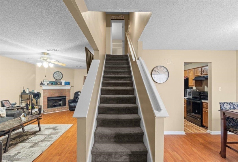 Carpeted staircase with white handrails