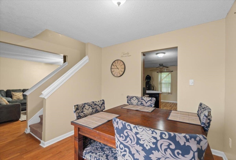 Dining area with wood-finish flooring and neutral wall tones