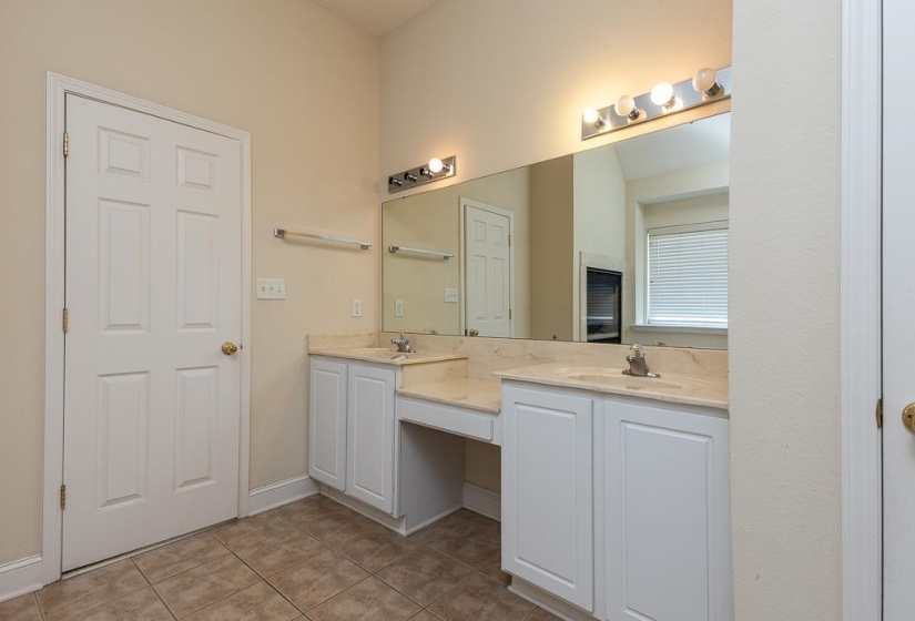 Dual vanity with light-toned countertops and integrated sinks