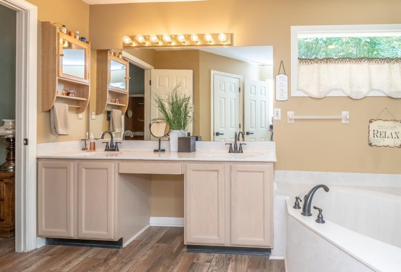 Double vanity featuring light-colored cabinetry, a light-toned countertop, and dark-finished fixtures