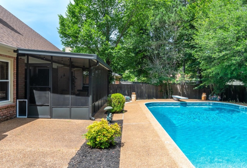 Screened porch with dark framing, brick exterior, and a large inground swimming pool
