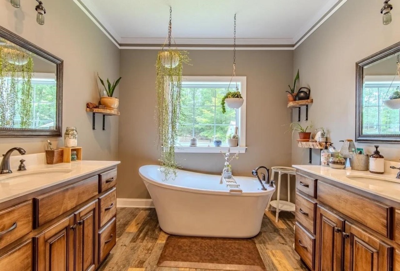 Freestanding soaking tub with a window backdrop