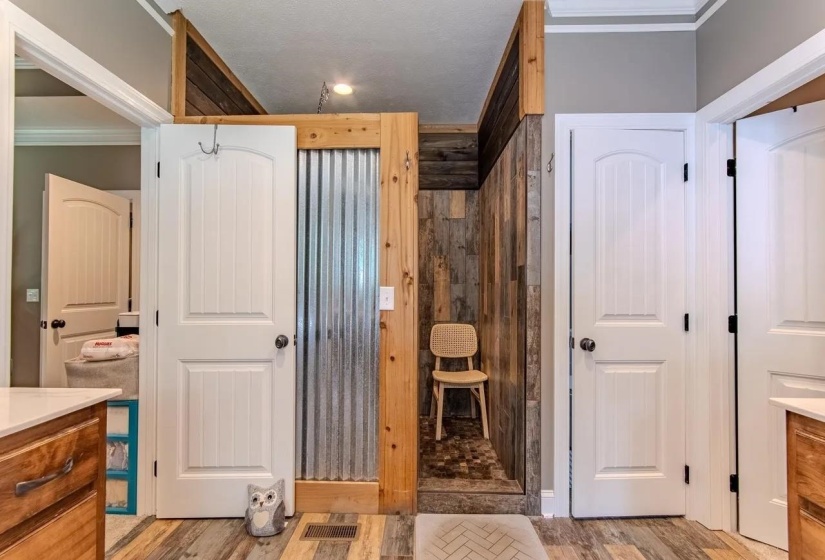 Walk-in shower featuring wood-finish paneling and a tiled floor