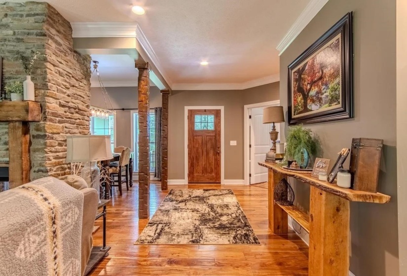 Inviting foyer with wood-finish flooring and a craftsman-style entry door