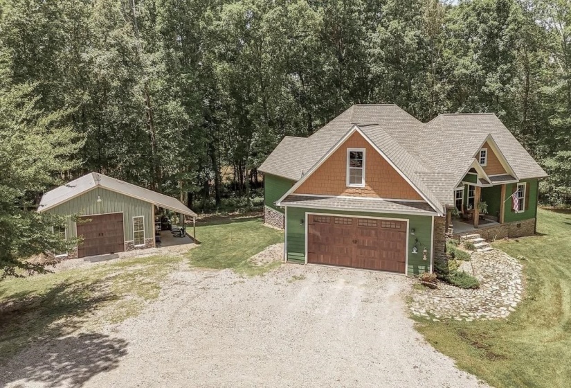 Craftsman-style residence featuring a prominent front garage with a wood-finish door