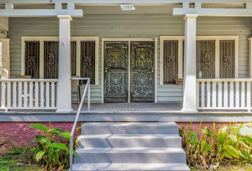 Doorway to property with covered porch