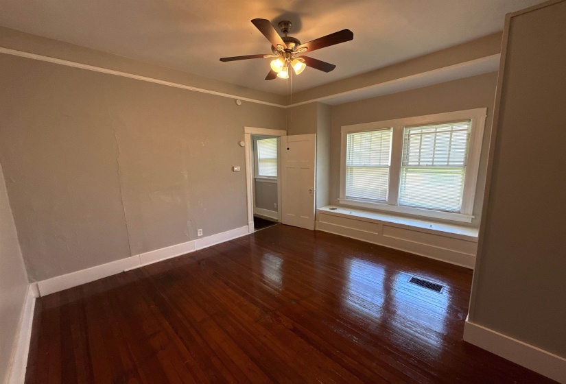 Empty room with wood finished floors and ceiling fan