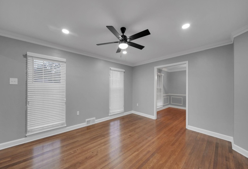 Empty room with ornamental molding, dark wood finished floors, ceiling fan, and recessed lighting