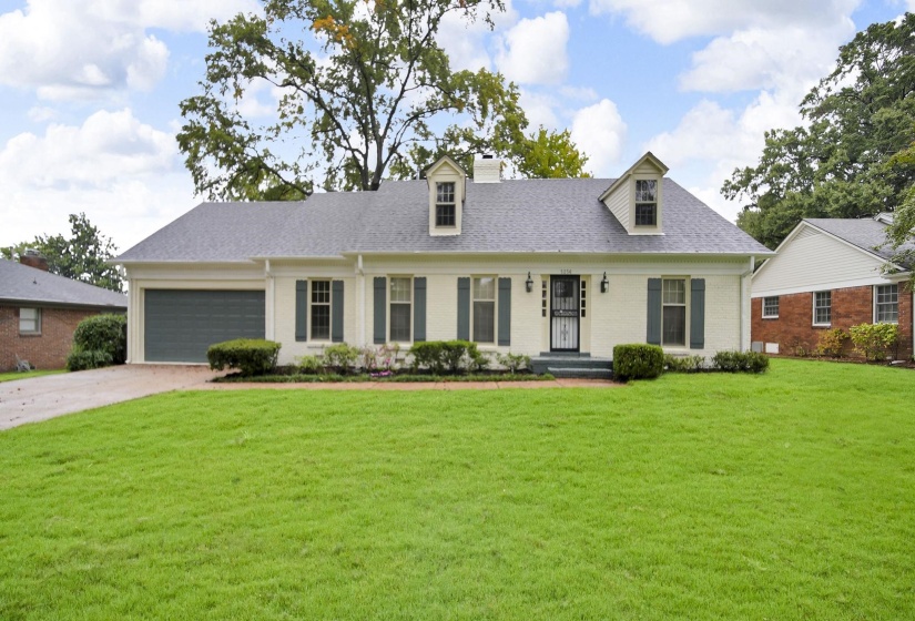 Cape cod-style house featuring covered porch, a front yard, driveway, and brick siding