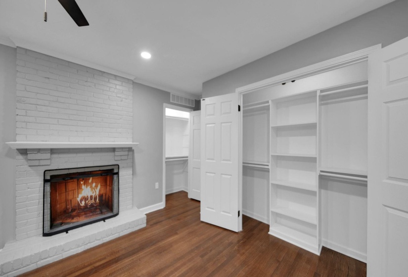 Unfurnished living room featuring a brick fireplace, dark wood finished floors, recessed lighting, and ceiling fan