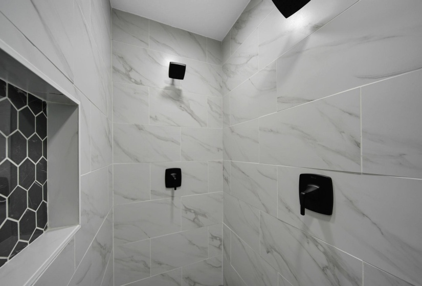 Bathroom featuring a marble finish shower