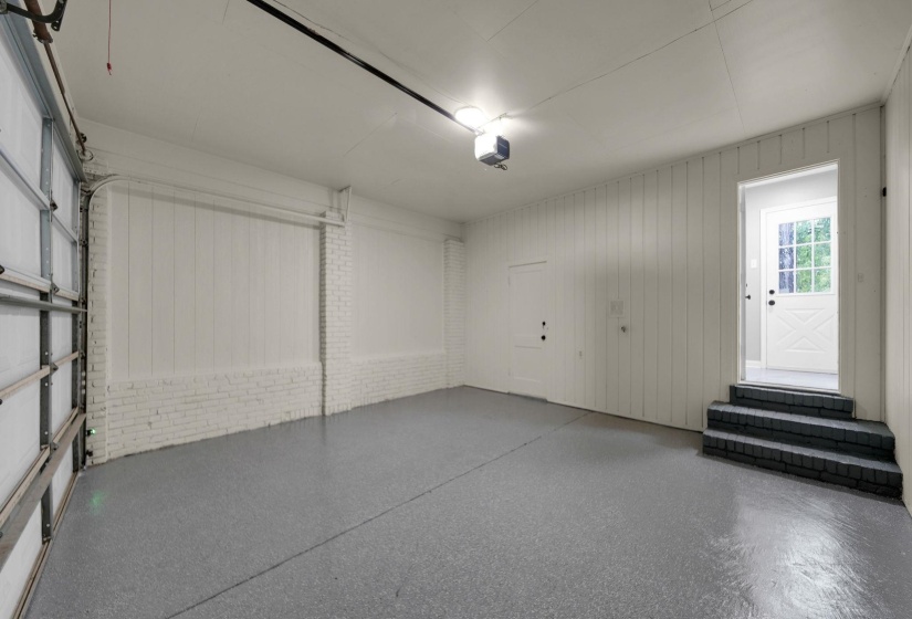Garage with wooden walls and a garage door opener