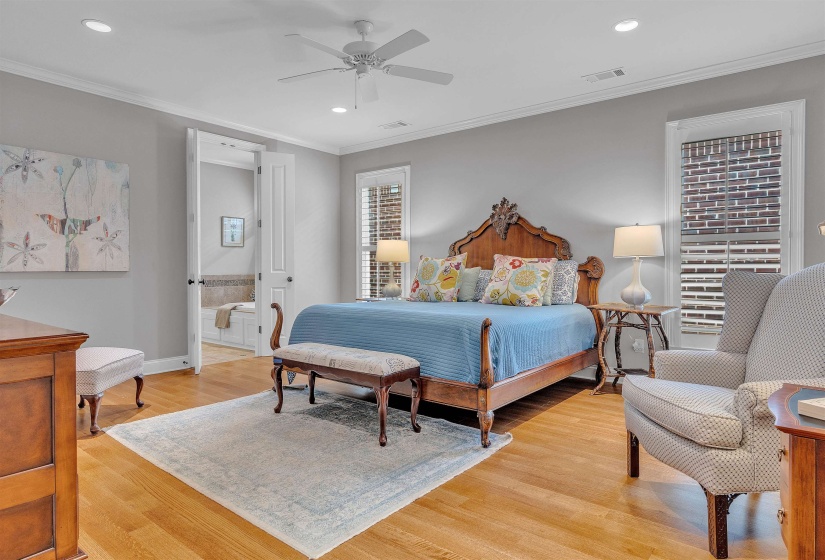 Spacious room featuring wood-finish flooring, recessed lighting, and a ceiling fan