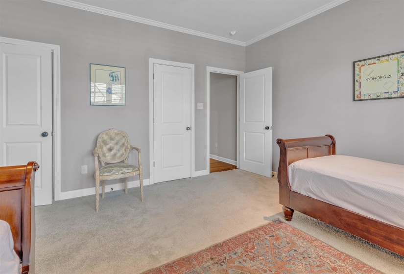Spacious room with light gray walls and white crown molding