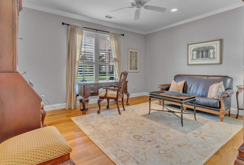 Room featuring hardwood flooring and light gray painted walls
