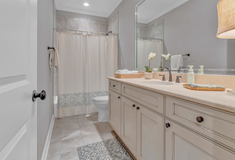 Dual-sink vanity with a light-toned countertop and paneled cabinetry