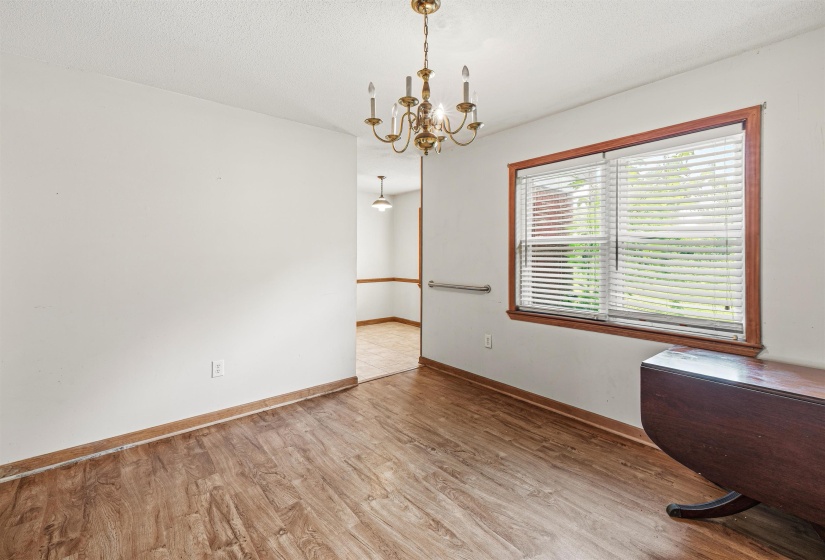 Interior room featuring wood-finish flooring and a brass chandelier